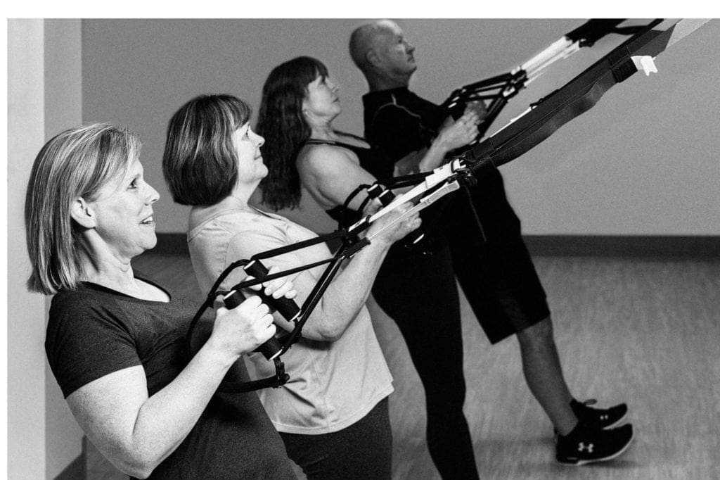 members at TRX classes working on suspension training