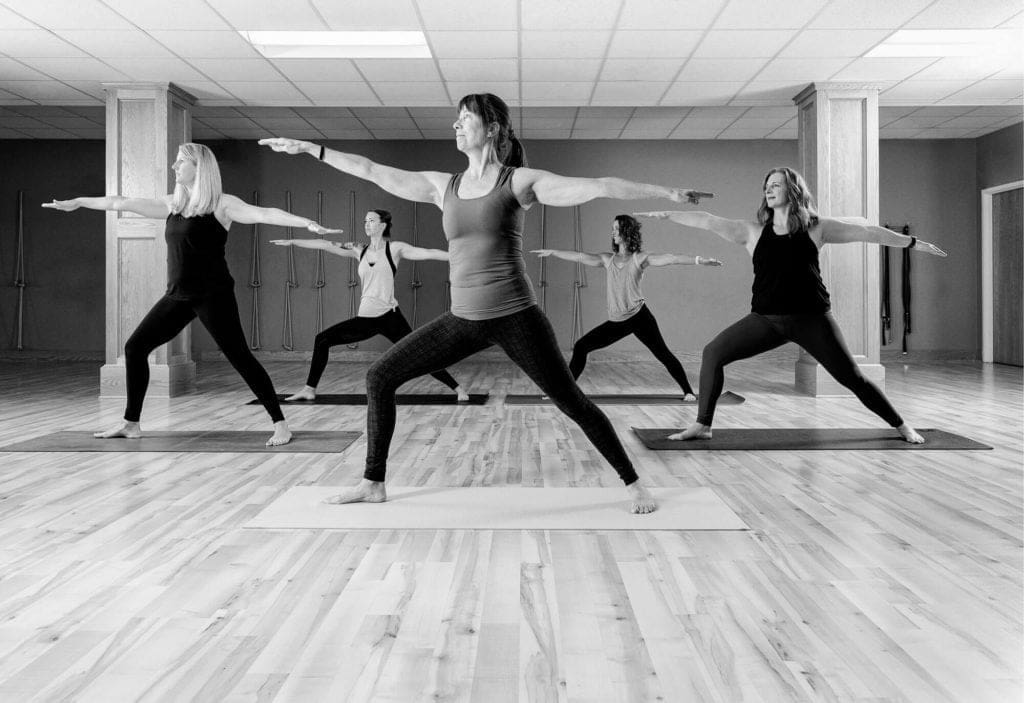 Yoga class in the middle of a pose at a yoga studio